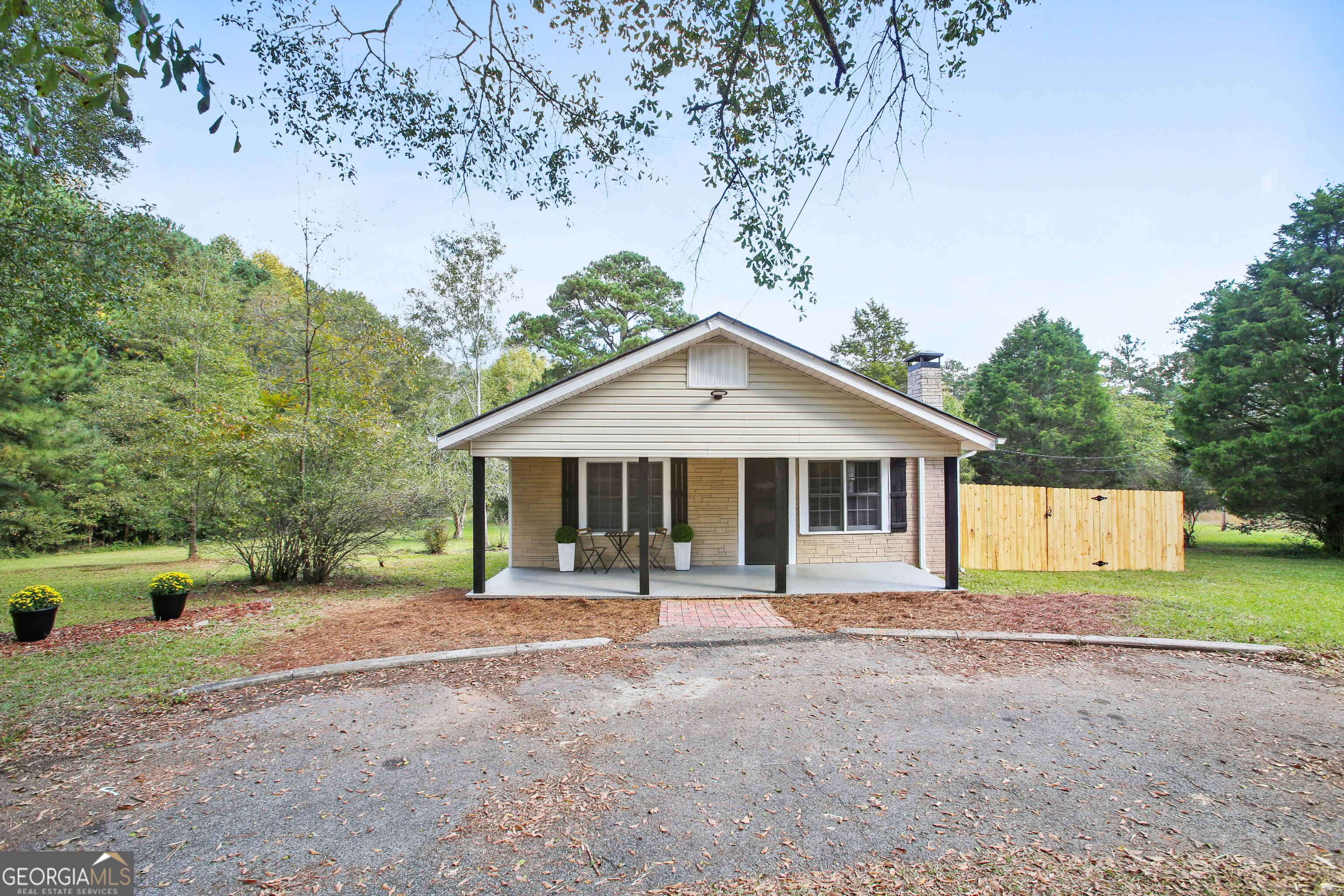 1220 East Atlanta Road Stockbridge, GA 30281 - Photo 1 of 1 a front view of a house with a yard and trees