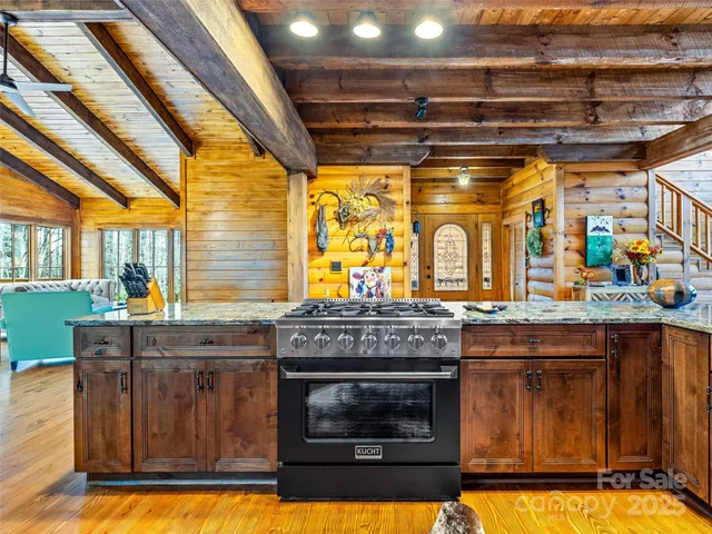 a kitchen with stainless steel appliances granite countertop a stove and a sink