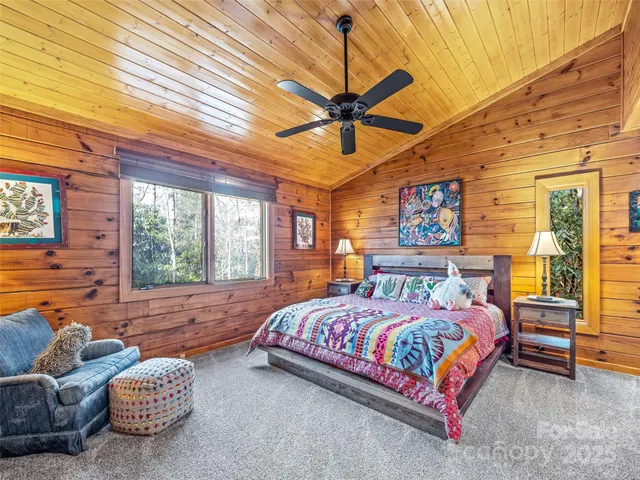 a bedroom with a bed couch and window