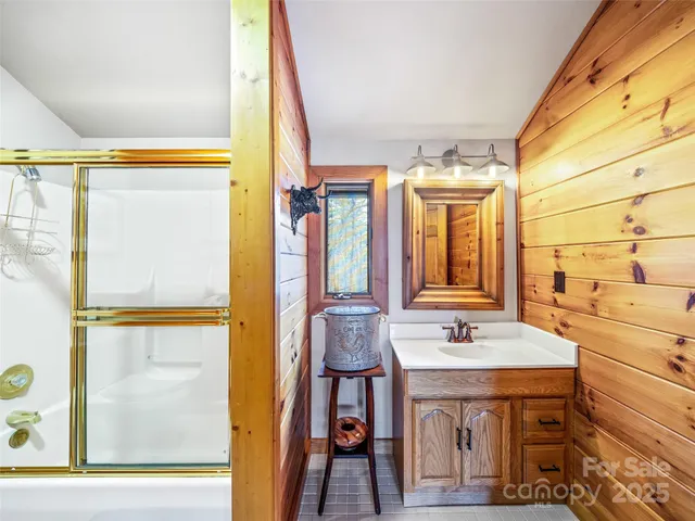 a spacious bathroom with a double vanity sink a mirror and a shower