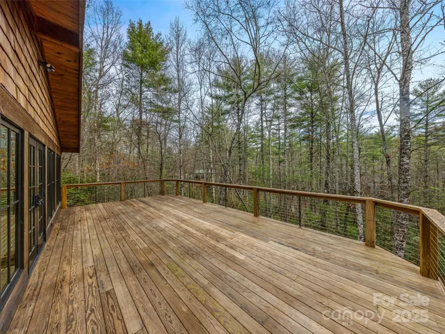 a view of balcony with wooden floor and fence