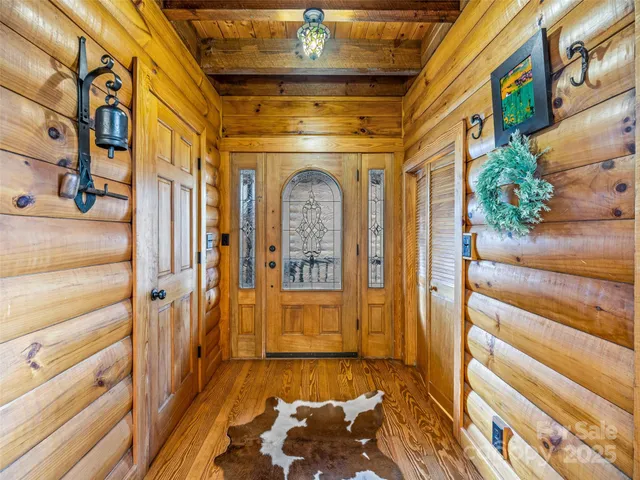 a view of entryway with a front door and wooden floor