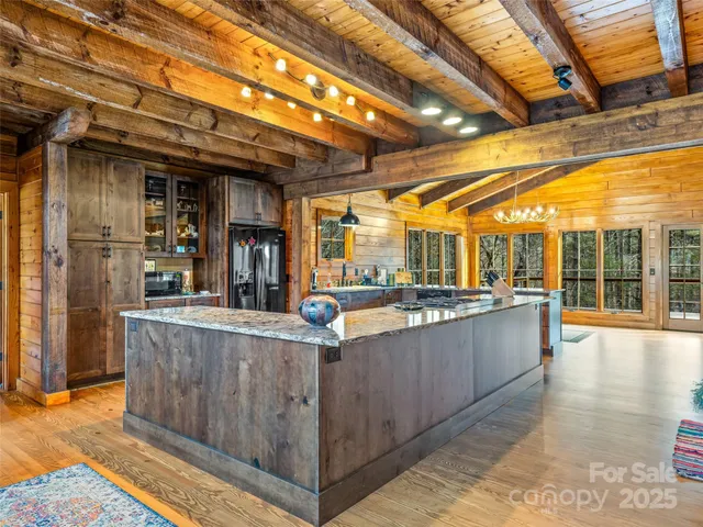 a view of a kitchen with a sink and wooden floor