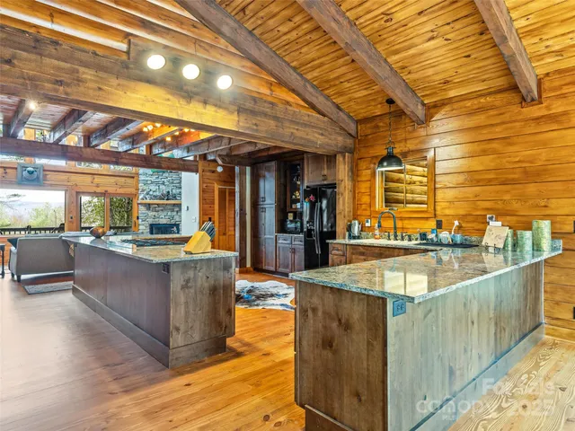 a kitchen with stainless steel appliances granite countertop a sink and a counter space