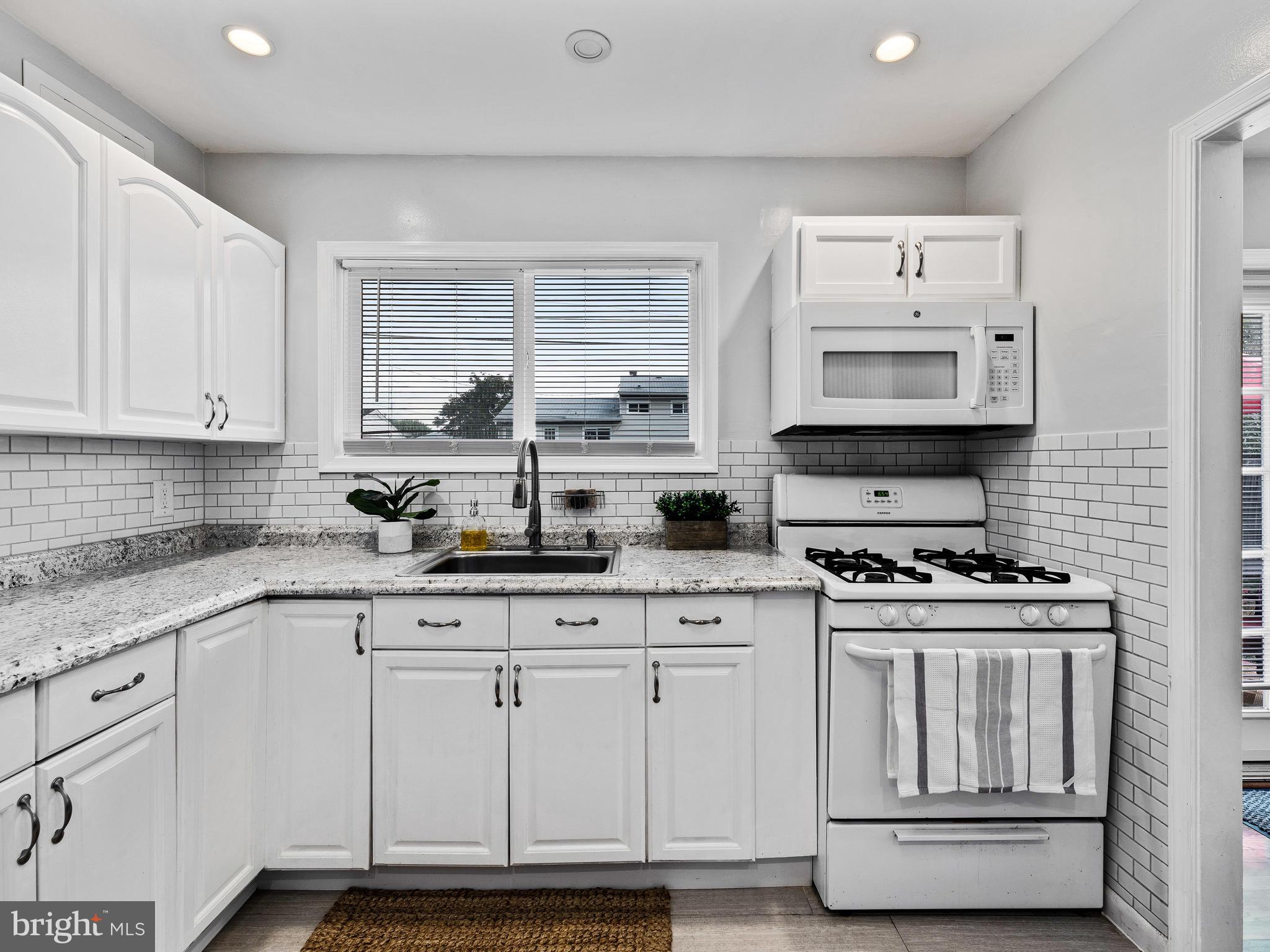 1023 Marksworth Road Baltimore, MD 21228 - Photo 11 of 33 New white kitchen w/ big window overlooking yard!