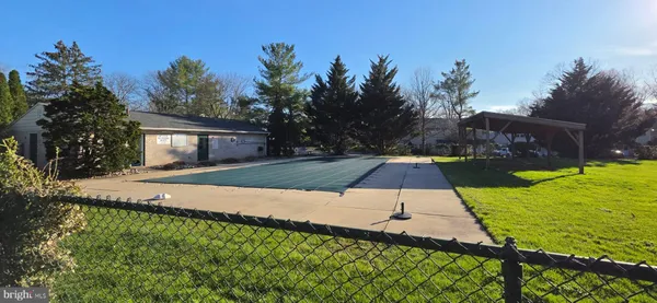 a view of yard with swimming pool and seating area
