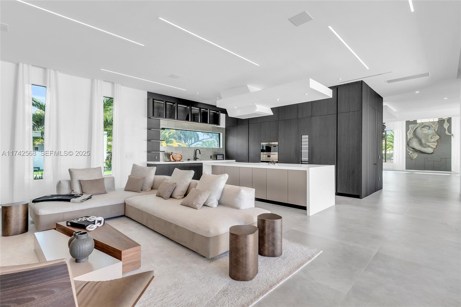 9890 Southwest 64th Street Miami, FL 33173 - Photo 17 of 61 a living room with furniture and large windows