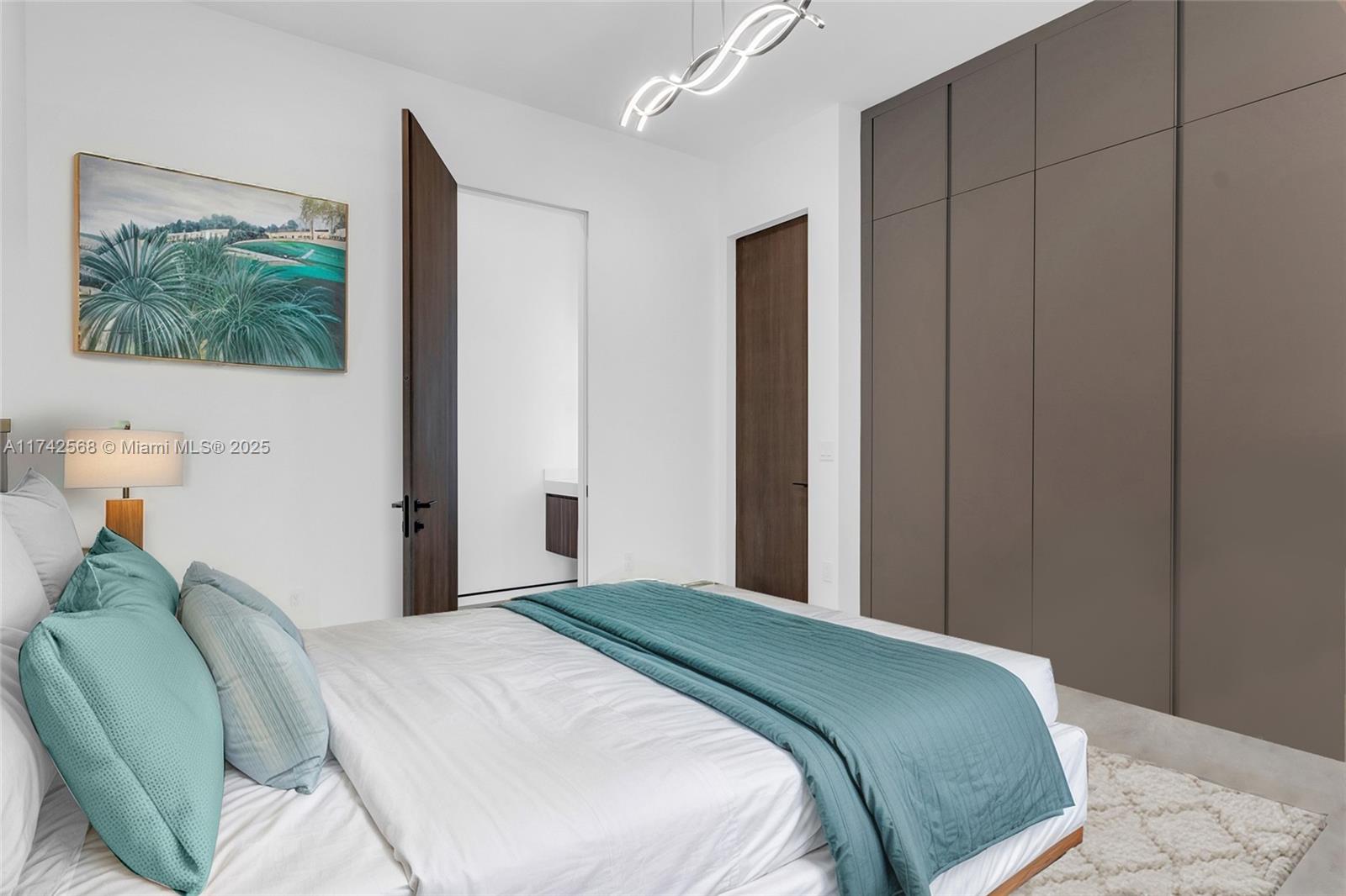 9890 Southwest 64th Street Miami, FL 33173 - Photo 22 of 61 a bedroom with a bed and a painting on the wall