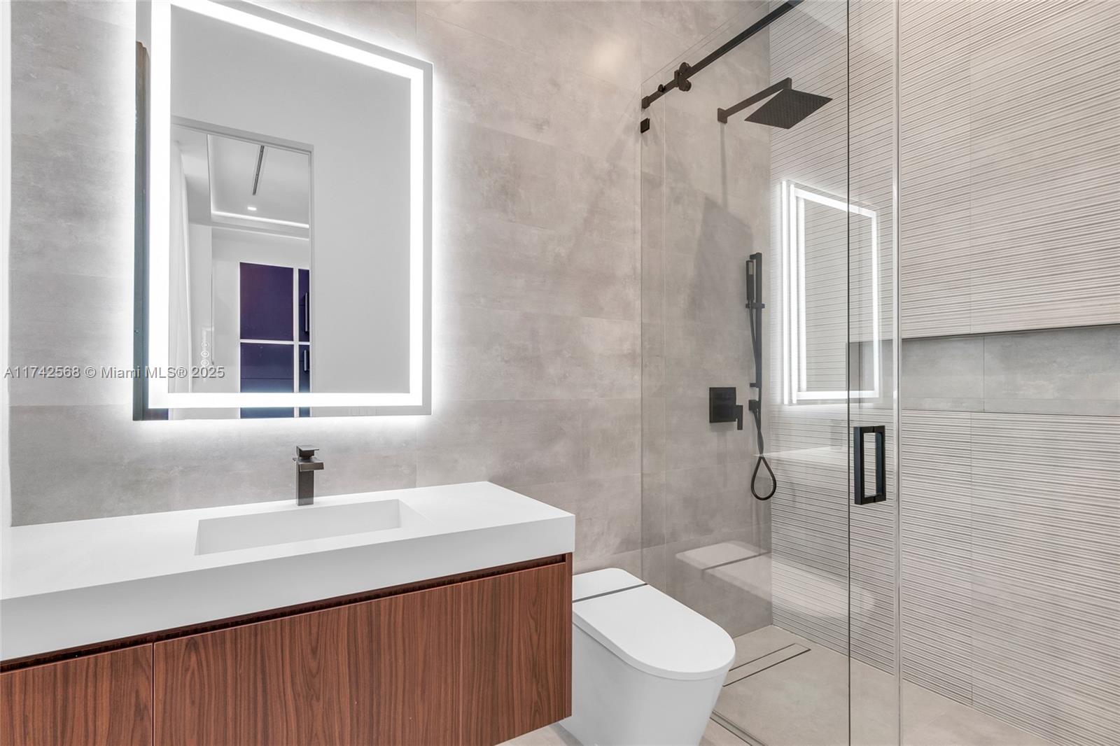 9890 Southwest 64th Street Miami, FL 33173 - Photo 23 of 61 a bathroom with a sink toilet and shower