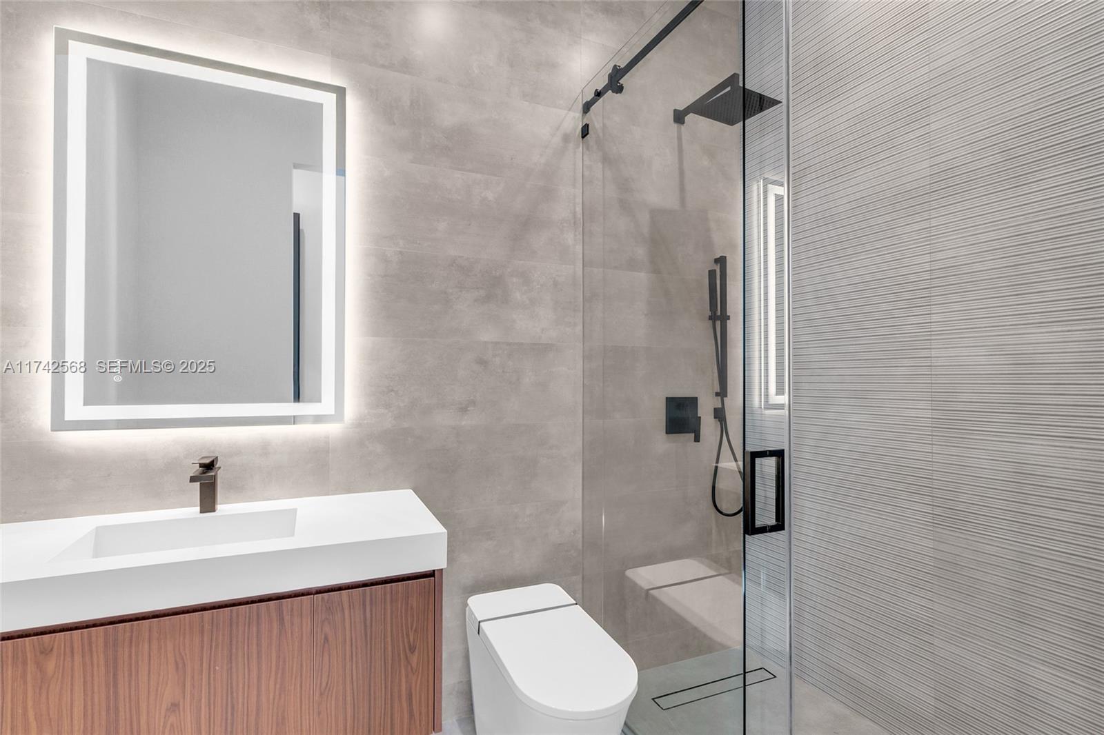 9890 Southwest 64th Street Miami, FL 33173 - Photo 26 of 61 a bathroom with a sink a toilet and shower