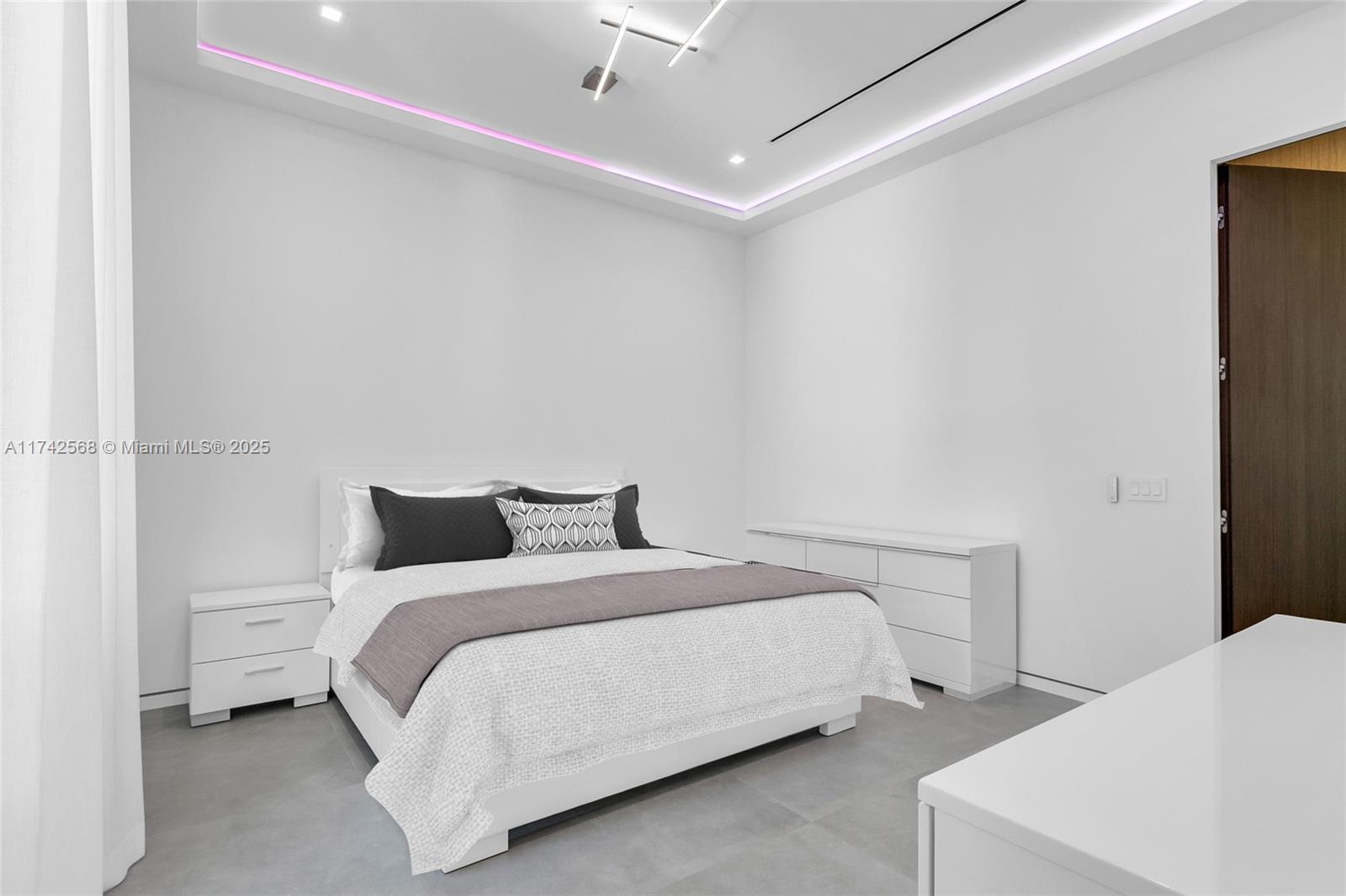 9890 Southwest 64th Street Miami, FL 33173 - Photo 28 of 61 a bedroom with a bed and a lamp