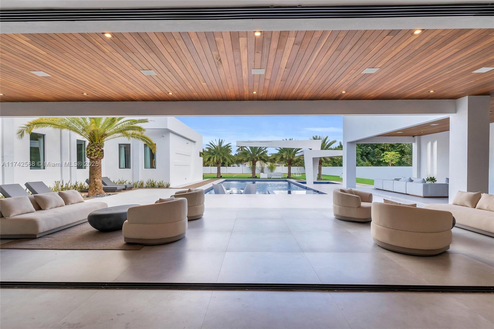 9890 Southwest 64th Street Miami, FL 33173 - Photo 39 of 61 a living room with furniture and a large window