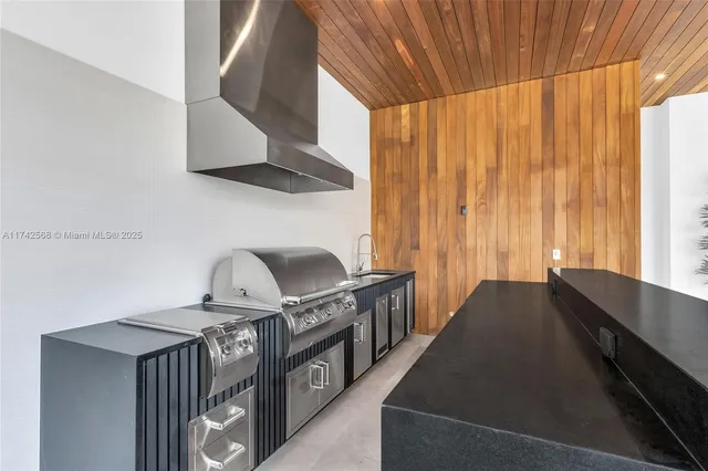 a view of a kitchen with kitchen island a stove and a wooden floors