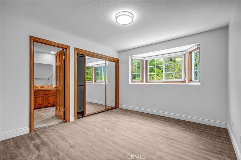 1249 Oakhaven Road Arcadia, CA 91006 - Photo 35 of 55 an empty room with wooden floor and windows
