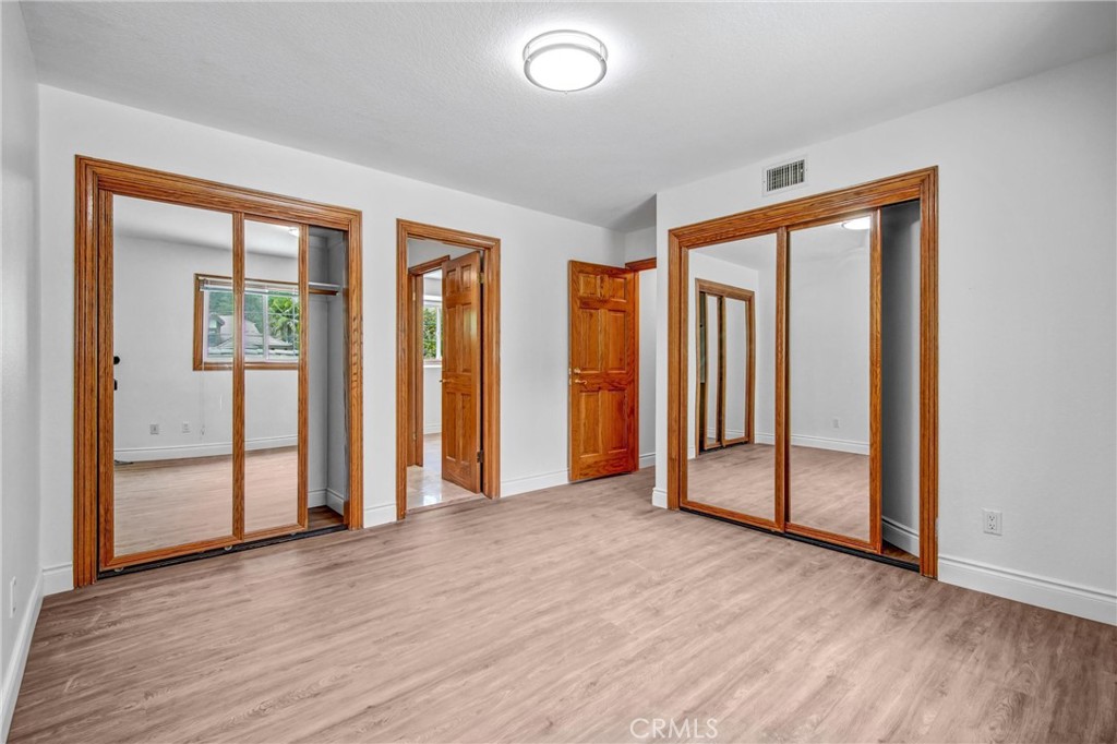 1249 Oakhaven Road Arcadia, CA 91006 - Photo 37 of 55 an empty room with wooden floor and windows