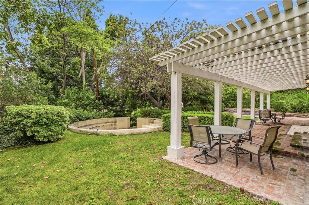 1249 Oakhaven Road Arcadia, CA 91006 - Photo 44 of 55 a view of a patio with table and chairs potted plants and large tree