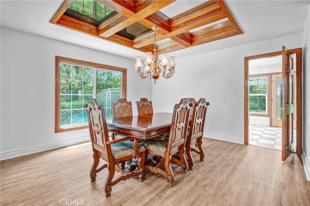 1249 Oakhaven Road Arcadia, CA 91006 - Photo 9 of 55 a dining room with furniture a chandelier and wooden floor
