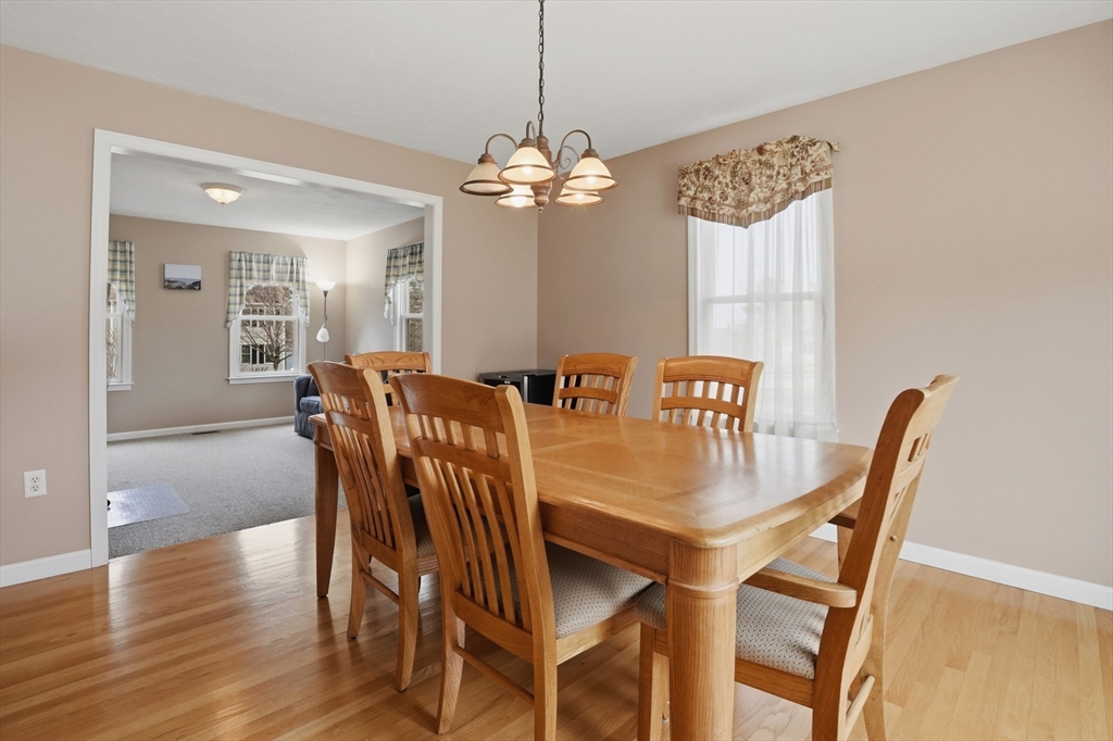 23 Bridle Path Auburn, MA 01501 - Photo 11 of 40 a view of a dining room with furniture a chandelier and wooden floor