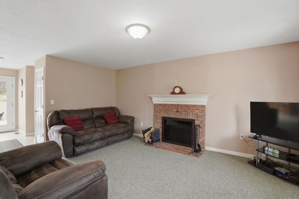 23 Bridle Path Auburn, MA 01501 - Photo 18 of 40 a living room with furniture and a flat screen tv