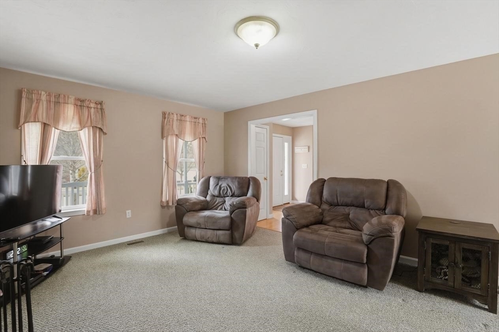 23 Bridle Path Auburn, MA 01501 - Photo 19 of 40 a living room with furniture and a flat screen tv