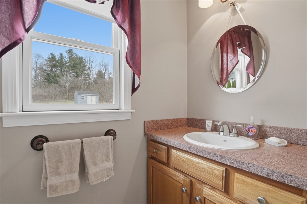 23 Bridle Path Auburn, MA 01501 - Photo 21 of 40 a bathroom with a sink and a mirror