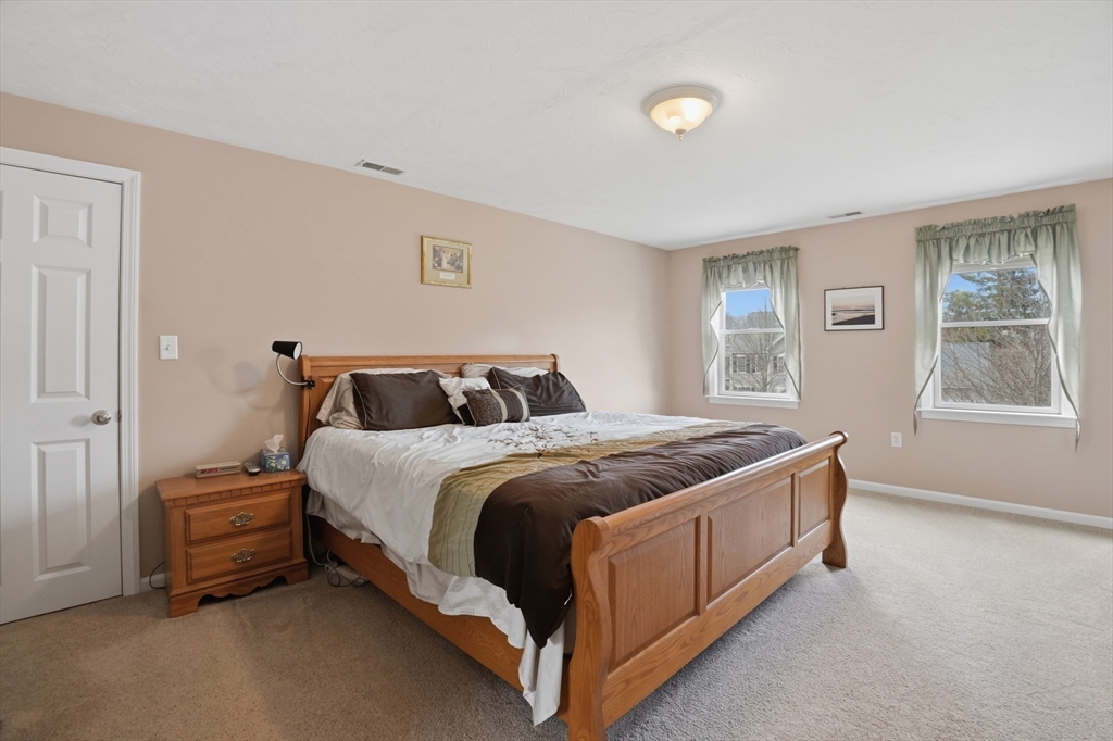 23 Bridle Path Auburn, MA 01501 - Photo 22 of 40 a spacious bedroom with a bed and window