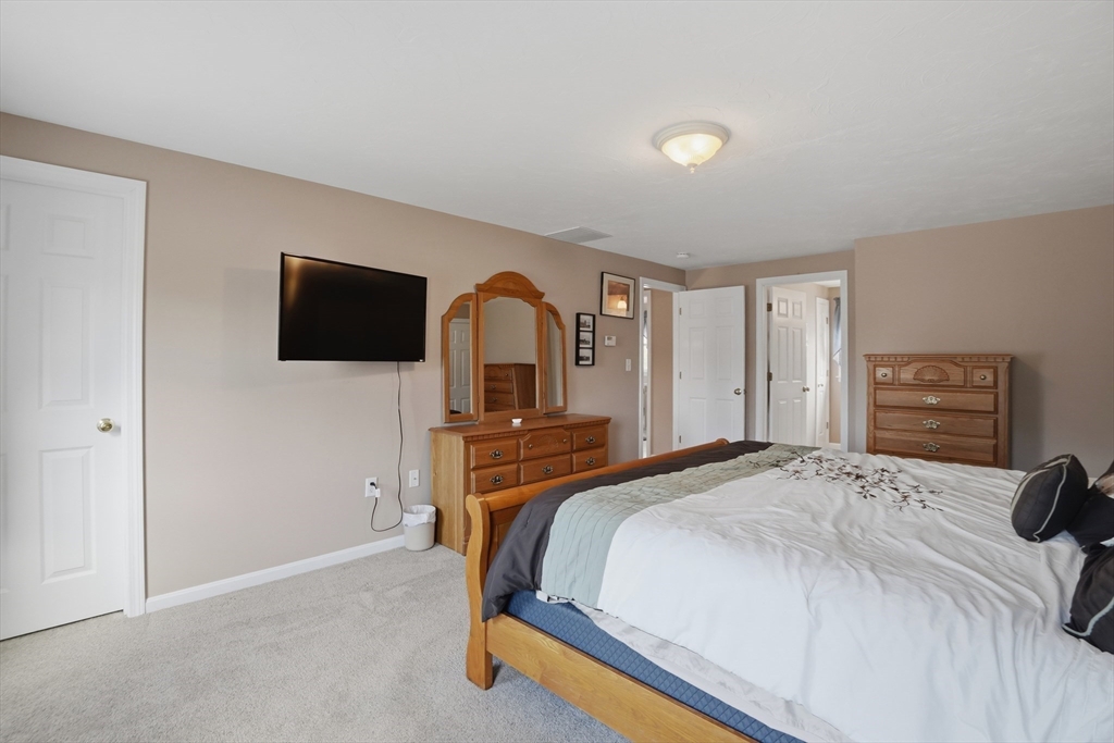 23 Bridle Path Auburn, MA 01501 - Photo 23 of 40 a bedroom with a bed and a flat screen tv