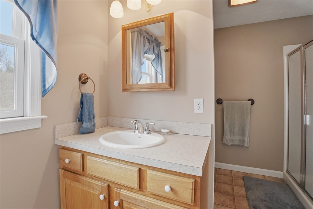 23 Bridle Path Auburn, MA 01501 - Photo 24 of 40 a bathroom with a sink and a mirror