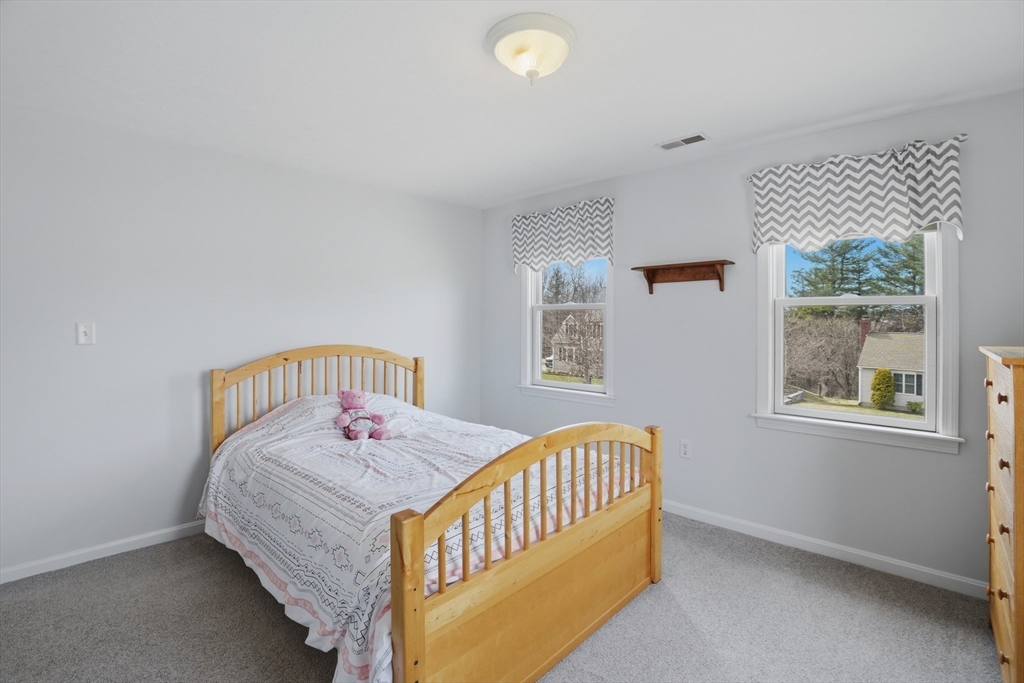 23 Bridle Path Auburn, MA 01501 - Photo 25 of 40 a bedroom with a bed and a window