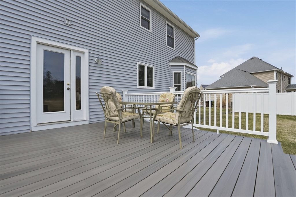 23 Bridle Path Auburn, MA 01501 - Photo 33 of 40 a view of a house with wooden deck and outdoor seating