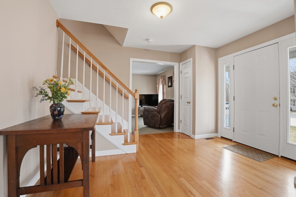 23 Bridle Path Auburn, MA 01501 - Photo 5 of 40 a living room with furniture flowerpot and wooden floor