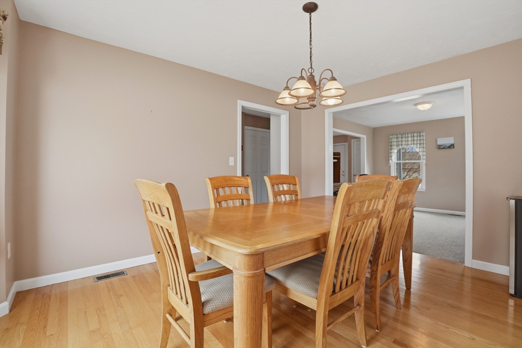 23 Bridle Path Auburn, MA 01501 - Photo 10 of 40 a view of a dining room with furniture wooden floor and chandelier
