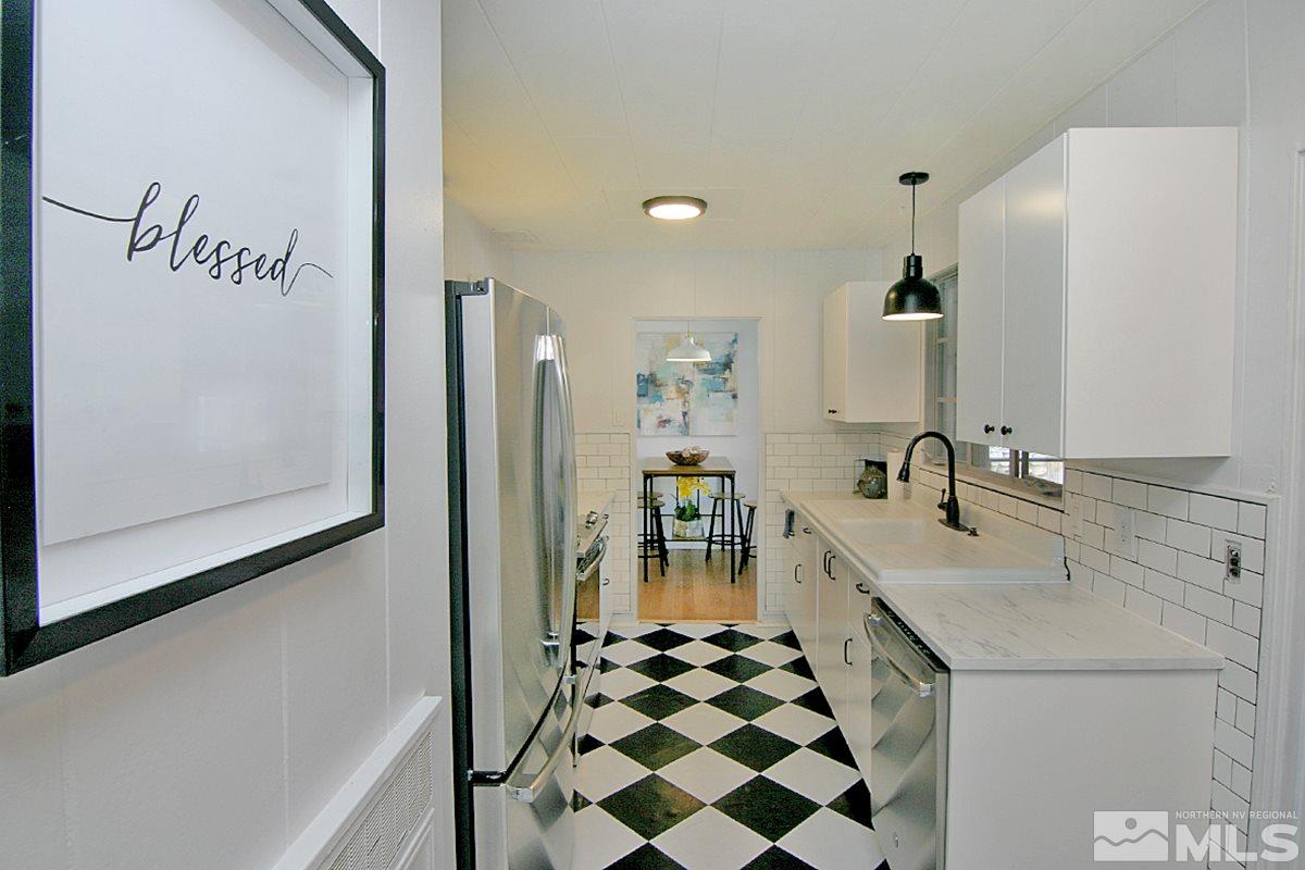 1425 Plumas Street Reno, NV 89509 - Photo 3 of 25 a kitchen with a sink a stove and cabinets