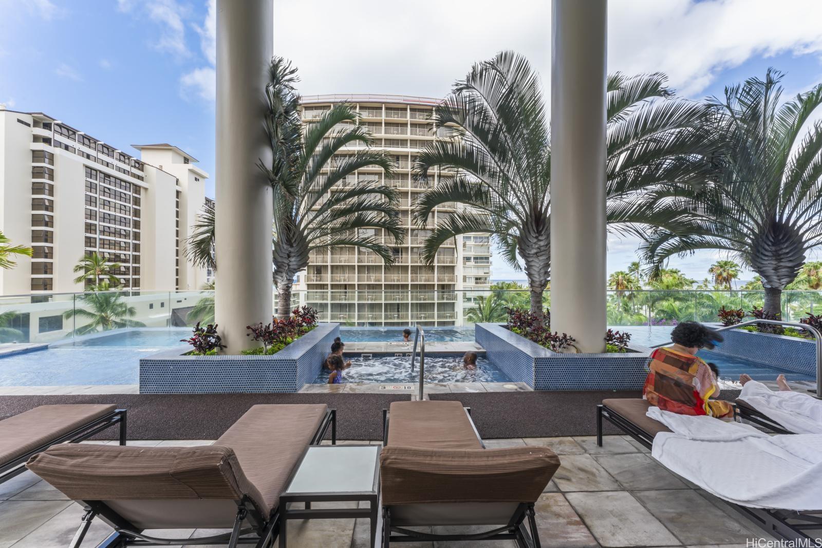 223 Saratoga Road, Unit 1102 Honolulu, HI 96815 - Photo 13 of 23 a view of a patio with couches and a potted plant on a table and chairs