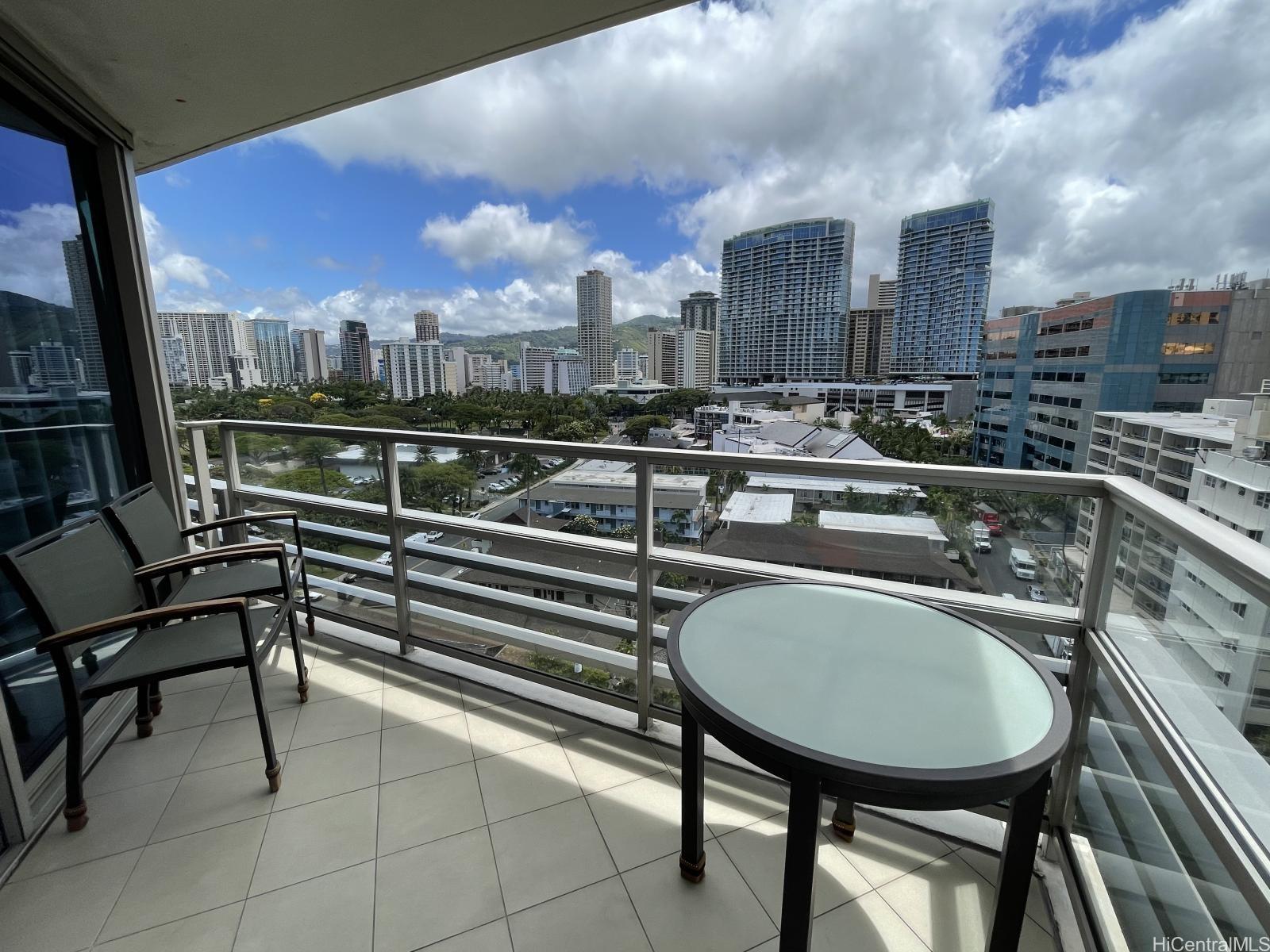 223 Saratoga Road, Unit 1102 Honolulu, HI 96815 - Photo 9 of 23 a balcony with table and chairs