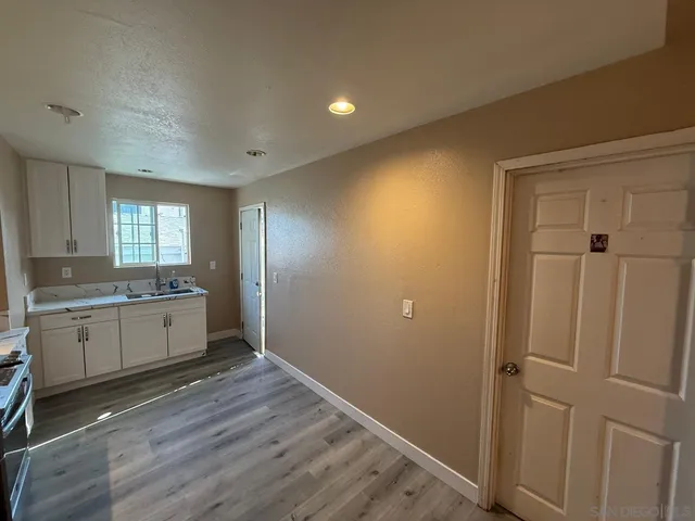 a room with a wooden floor and window