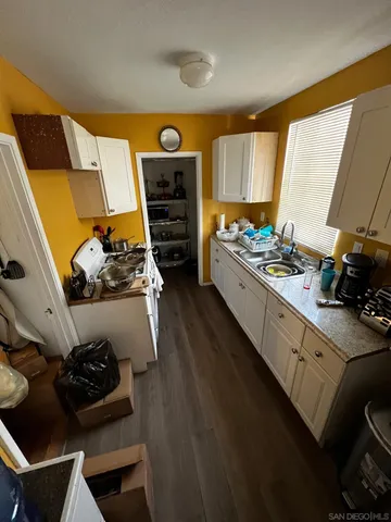 a kitchen with a sink appliances and cabinets