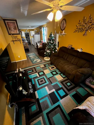 a picture of a living room with a rug and a fireplace