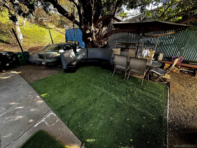 a view of a backyard with sitting area