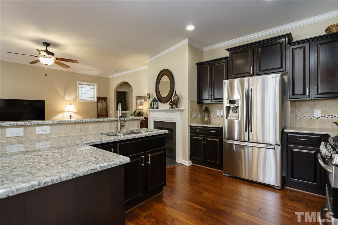 1533 Fullerton Place Raleigh, NC 27607 - Photo 11 of 25 GRANITE COUNTERTOPS, TILE BACKSPLASH AND STAGGERED UPPER CABINETS MAKE THIS KITCHEN STATE OF THE ART!