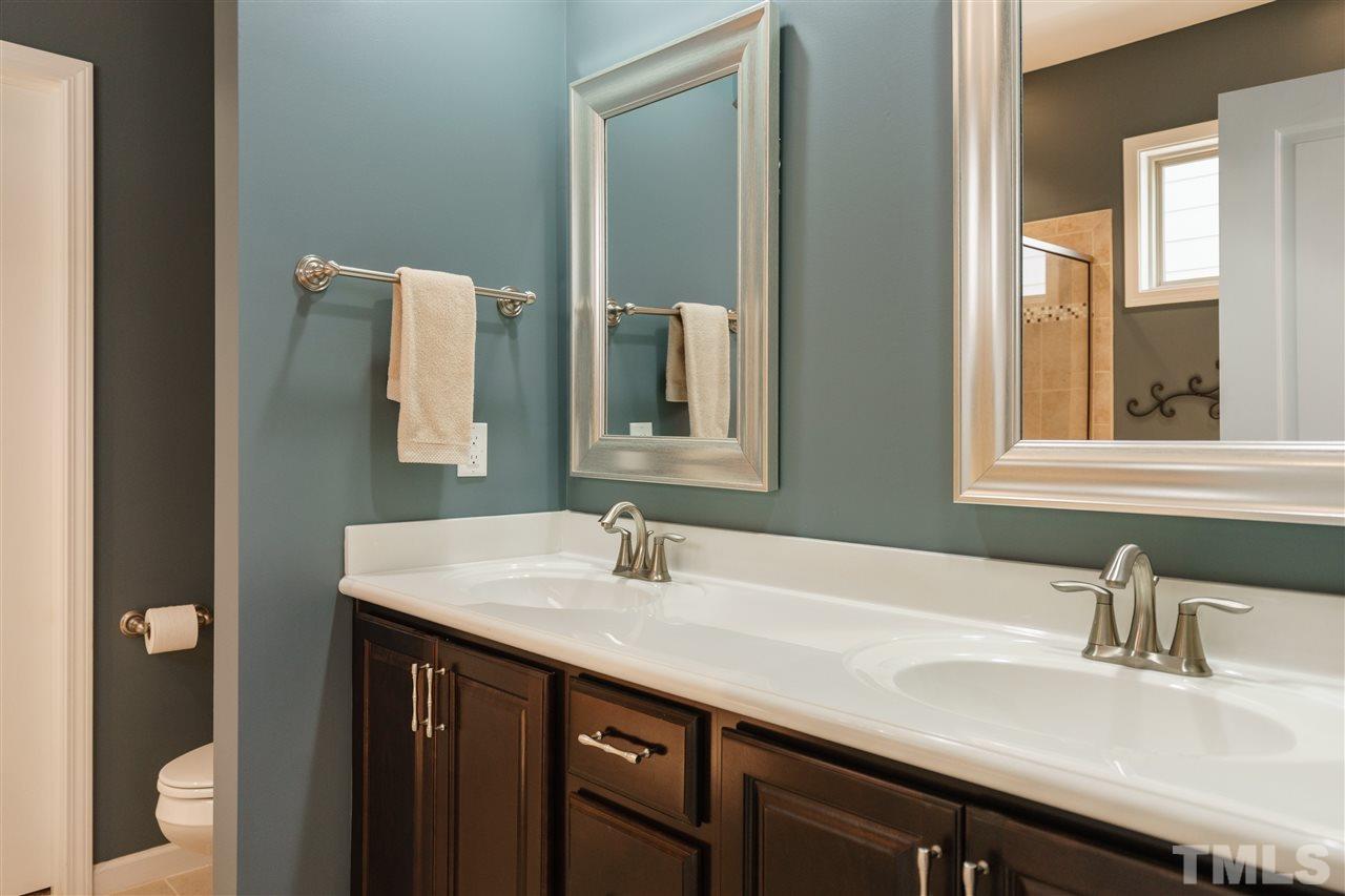 1533 Fullerton Place Raleigh, NC 27607 - Photo 14 of 25 MASTER BATHROOM CONNECTING TO MASTER BEDROOM WITH GARDEN TUB, SEPARATE TILE SHOWER, DOUBLE SINKS, AND CERAMIC TILE FLOOR.