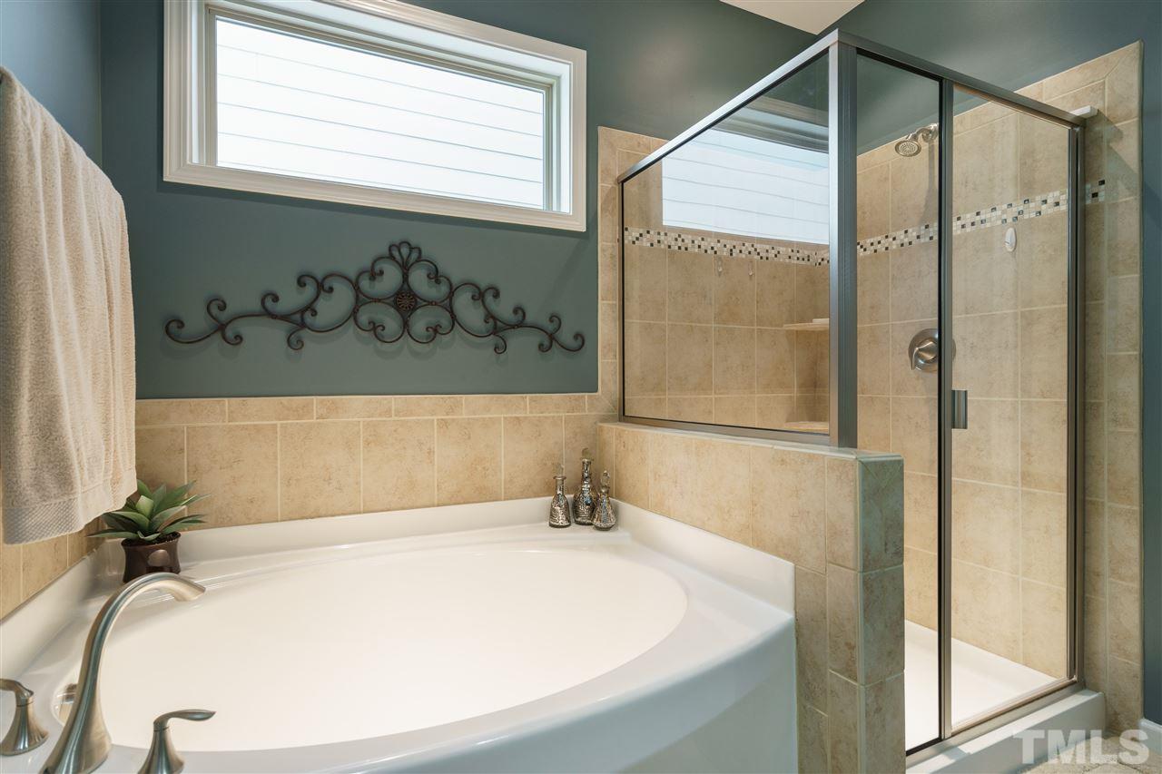 1533 Fullerton Place Raleigh, NC 27607 - Photo 15 of 25 MASTER BATHROOM CONNECTING TO MASTER BEDROOM WITH GARDEN TUB, SEPARATE SHOWER, DOUBLE SINKS AND CERAMIC TILE FLOOR.