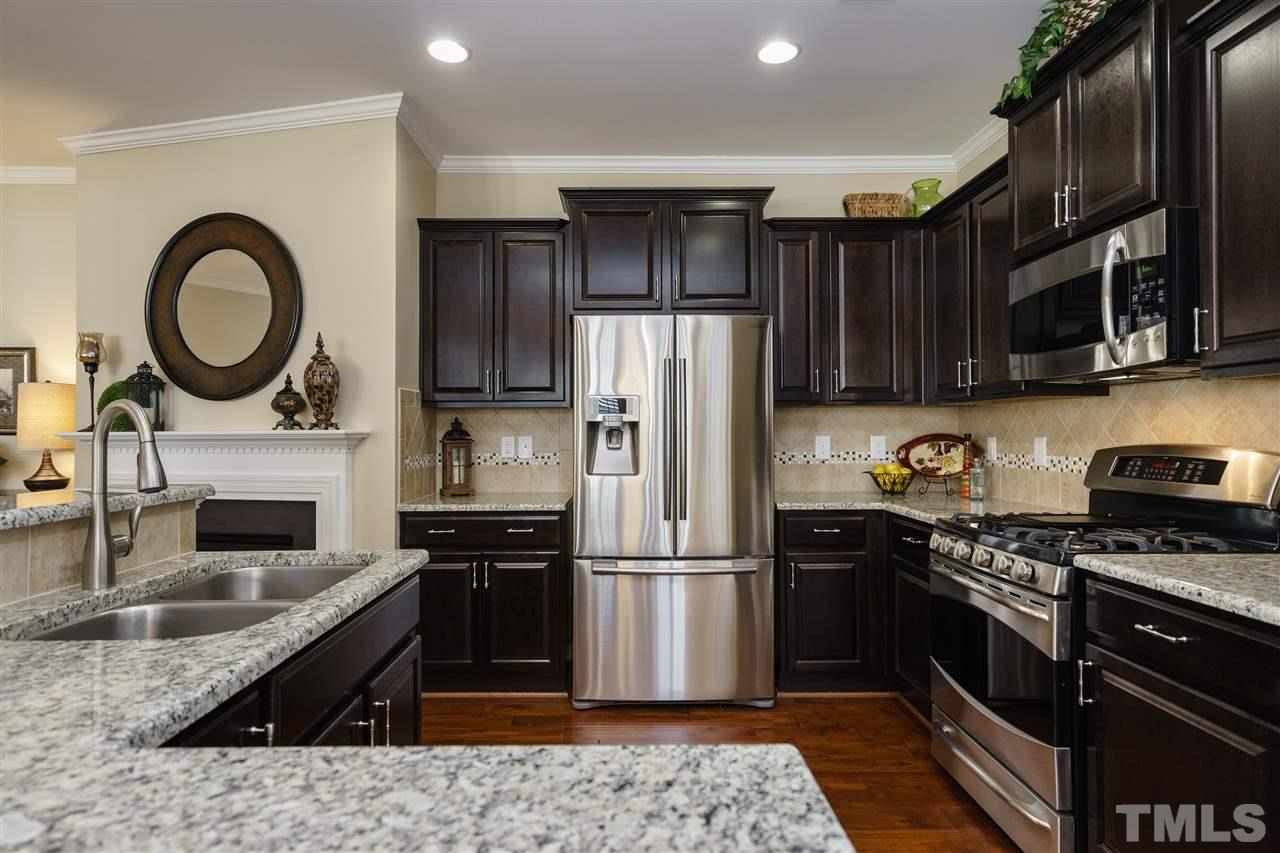 1533 Fullerton Place Raleigh, NC 27607 - Photo 9 of 25 BEAUTIFUL KITCHEN INCLUDES HARDWOODS, SS APPLIANCES, GRANITE COUNTERTOPS, AND ISLAND/BAR AREA.