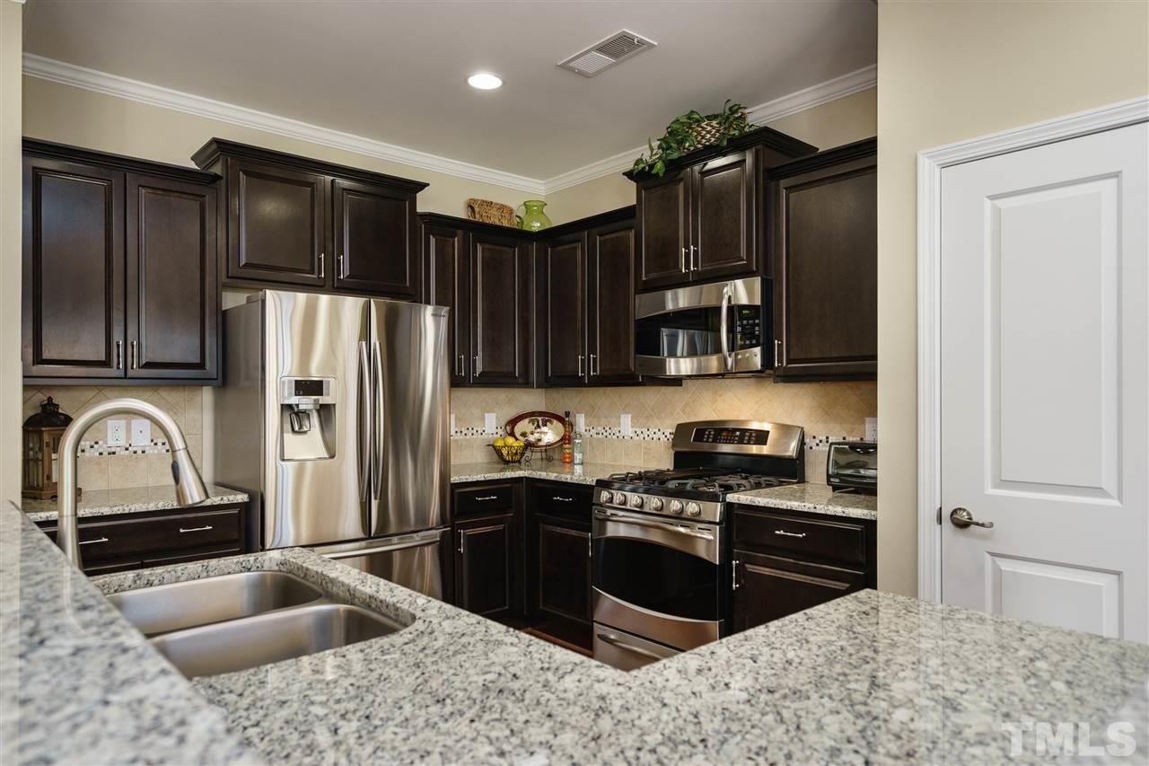 1533 Fullerton Place Raleigh, NC 27607 - Photo 10 of 25 ALL UPGRADED SS APPLIANCES INCLUDED: REFRIGERATOR, MICROWAVE, DISHWASHER, GAS OVEN/RANGE. PANTRY WITH WOODEN SHELVING TOO!