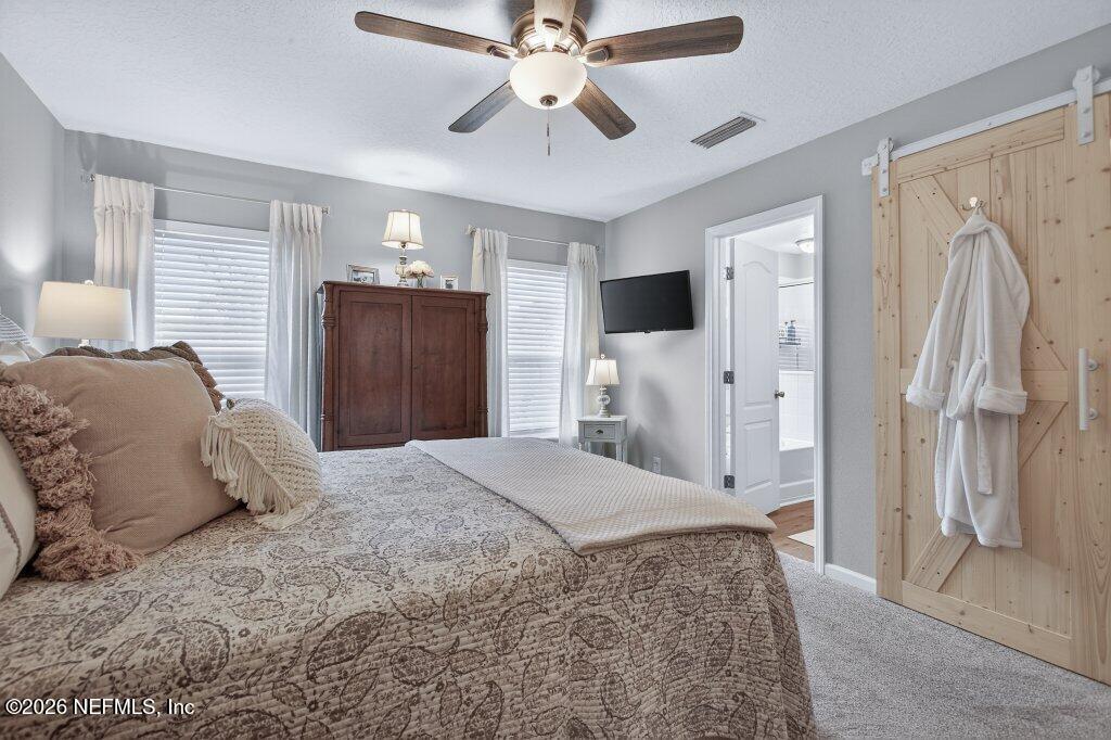 9652 Bridgeway Avenue Jacksonville, FL 32222 - Photo 17 of 35 a spacious bedroom with a bed and a walk in closet