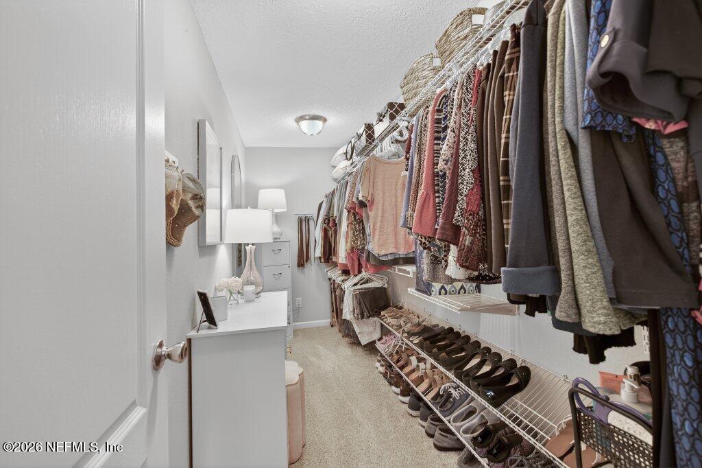 9652 Bridgeway Avenue Jacksonville, FL 32222 - Photo 18 of 35 a view of walk in closet with clothes and shoes