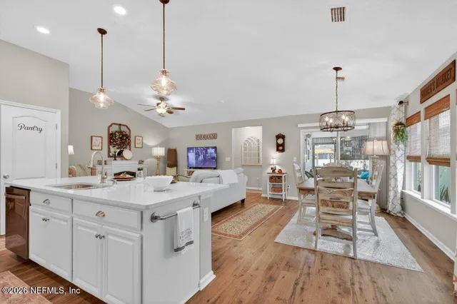 a living room with furniture and a ceiling fan