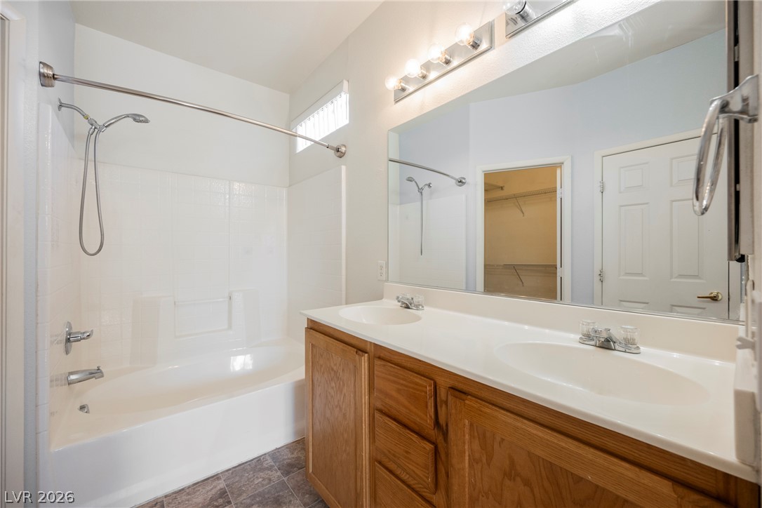 6320 Snap Ridge Street, Unit 201 North Las Vegas, NV 89081 - Photo 9 of 56 Double vanity sinks and a shower/tub combo make for an efficient bathroom space.