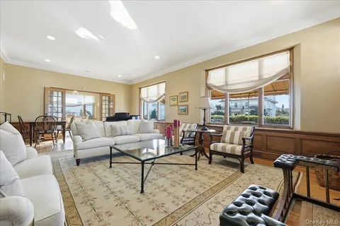 a living room with furniture a large window and a fireplace