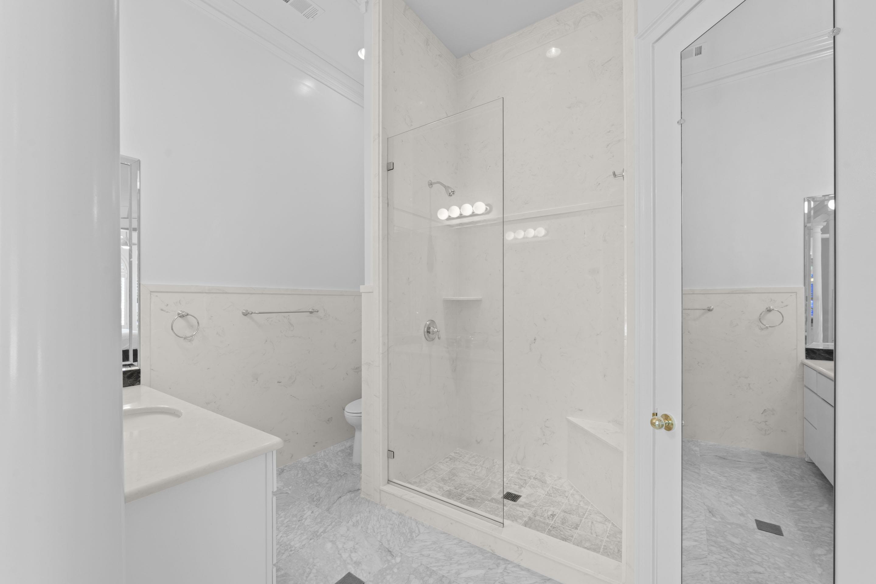 881 Bray Station Road Collierville, TN 38017 - Photo 17 of 40 Full bath featuring tile walls, a wainscoted wall, vanity, and a stall shower